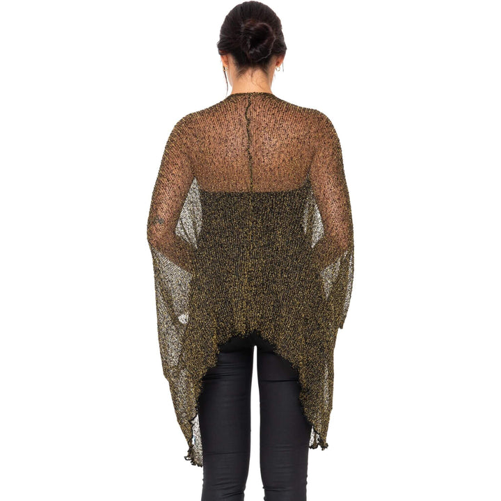 SHU-SHI metallic evening cardigan in black-gold with sheer lightweight fabric, worn open over black pants by a model photographed from behind against a white studio background.