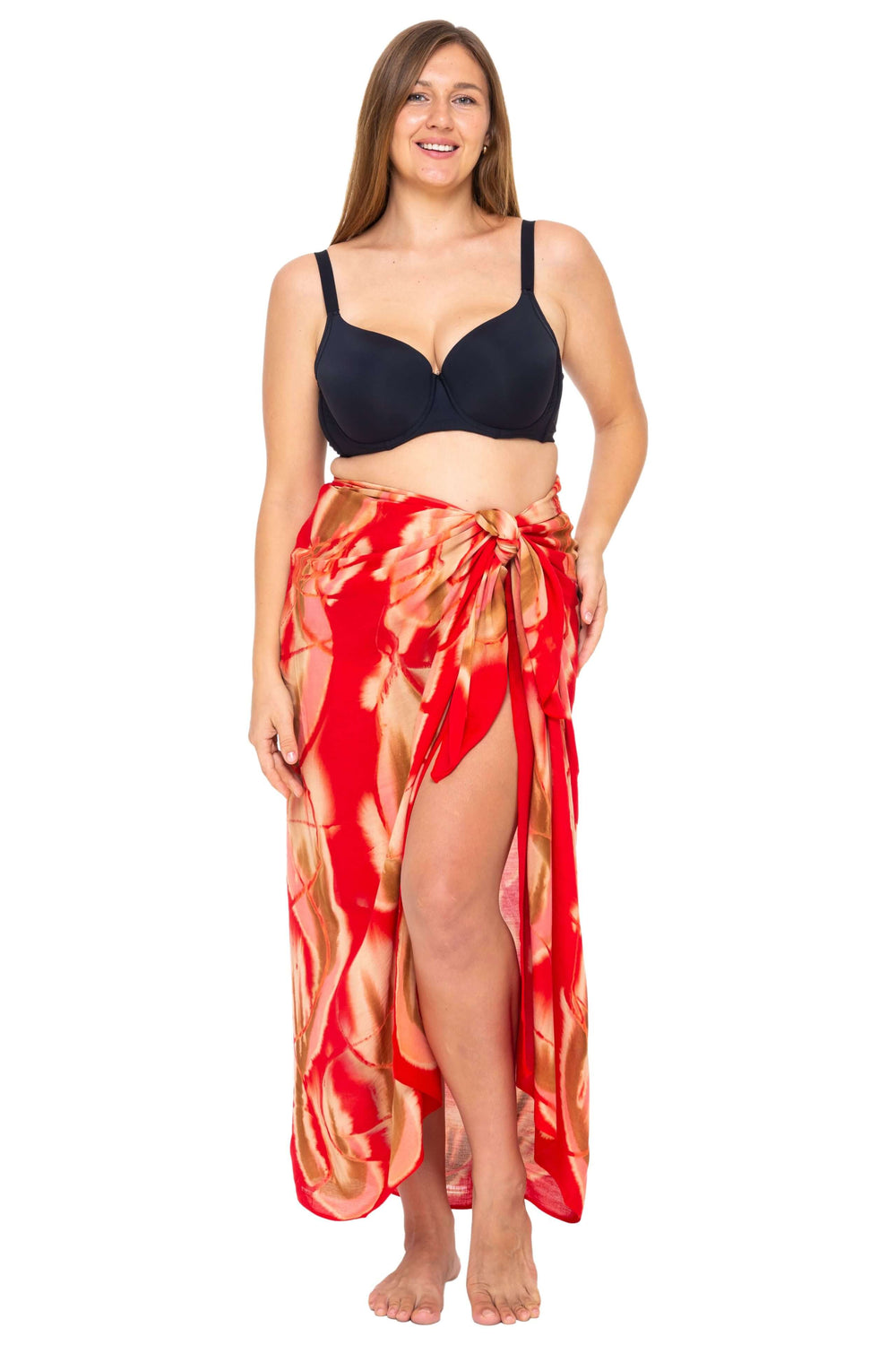 Woman wearing a black bikini and a Red  Tie-Dye Sarong Wrap Cover-Up for Women by SHU-SHI, styled as a long wrap skirt. Lightweight rayon beach cover-up, perfect for vacations, poolside lounging, tropical beach getaways, cruises, and resort wear.