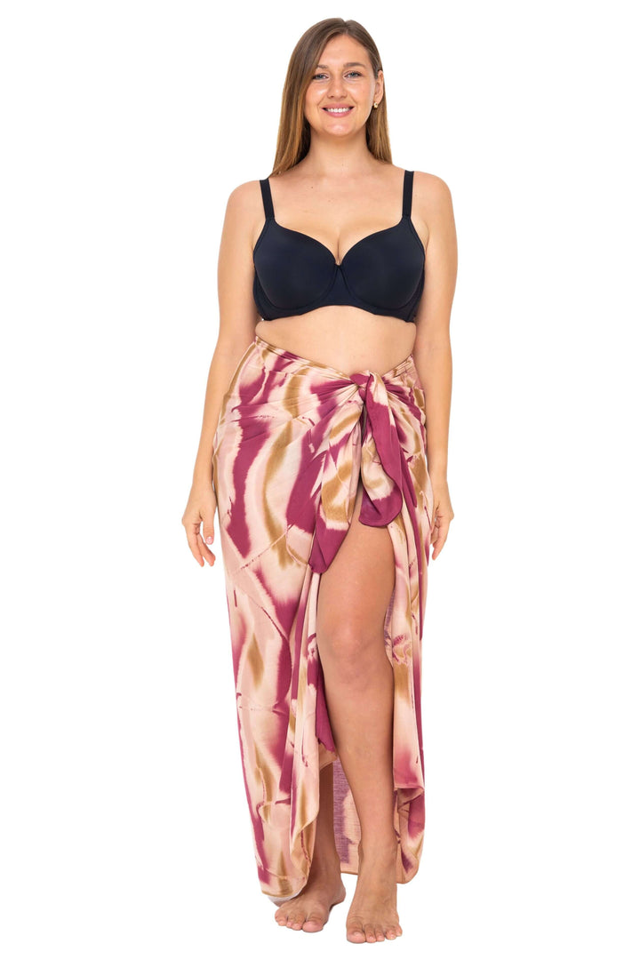 Woman wearing a black bikini and a burgundy  Tie-Dye Sarong Wrap Cover-Up for Women by SHU-SHI, styled as a long wrap skirt. Lightweight rayon beach cover-up, perfect for vacations, poolside lounging, tropical beach getaways, cruises, and resort wear.
