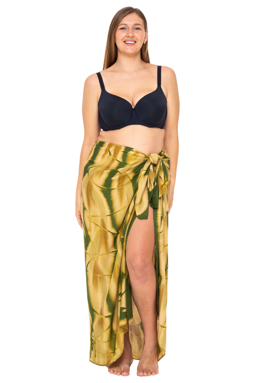 Woman wearing a black bikini and a Olive  Tie-Dye Sarong Wrap Cover-Up for Women by SHU-SHI, styled as a long wrap skirt. Lightweight rayon beach cover-up, perfect for vacations, poolside lounging, tropical beach getaways, cruises, and resort wear.