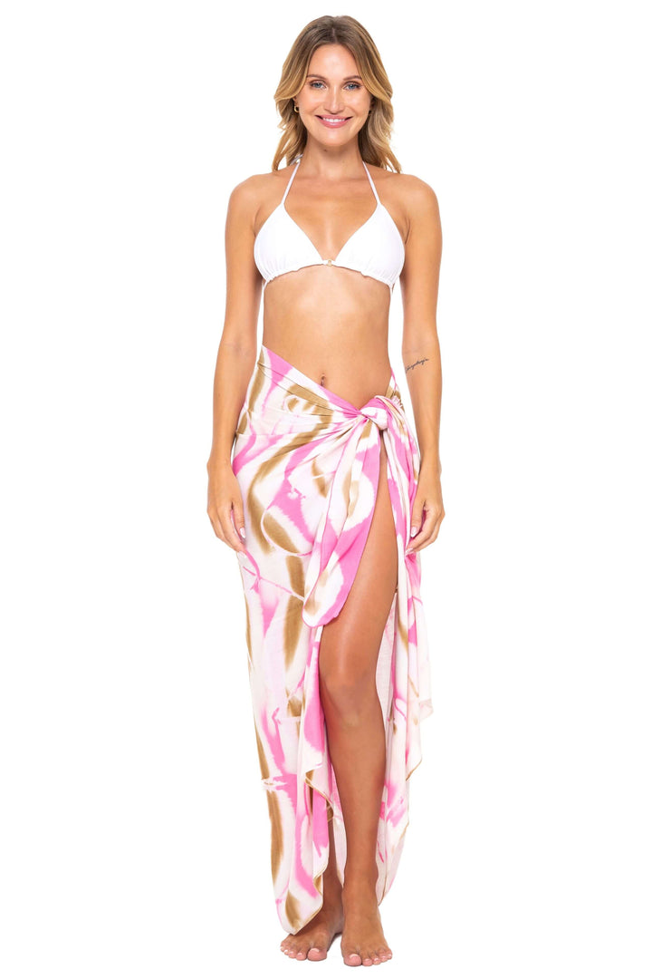 Woman wearing a black bikini and a pink  Tie-Dye Sarong Wrap Cover-Up for Women by SHU-SHI, styled as a long wrap skirt. Lightweight rayon beach cover-up, perfect for vacations, poolside lounging, tropical beach getaways, cruises, and resort wear.