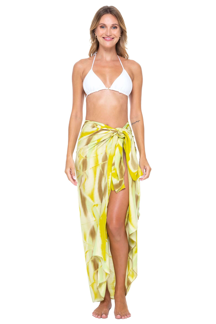 Woman wearing a black bikini and a yellow  Tie-Dye Sarong Wrap Cover-Up for Women by SHU-SHI, styled as a long wrap skirt. Lightweight rayon beach cover-up, perfect for vacations, poolside lounging, tropical beach getaways, cruises, and resort wear.
